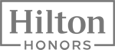 The image shows the Hilton Honors logo, featuring the words "Hilton Honors" in a bold, contemporary text style within a rectangular outline.